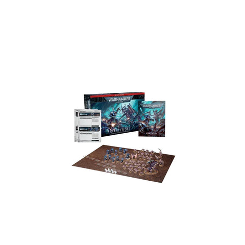 Warhammer 40,000 starter set with game box, rulebook, cards, and painted miniatures on board.