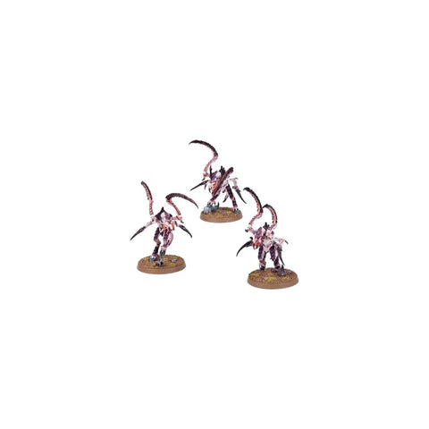 Three painted alien creature miniatures with claws on round bases, tabletop gaming figures