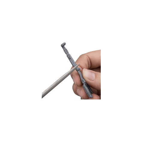 Hand using a modeling file tool to shape a small plastic miniature part