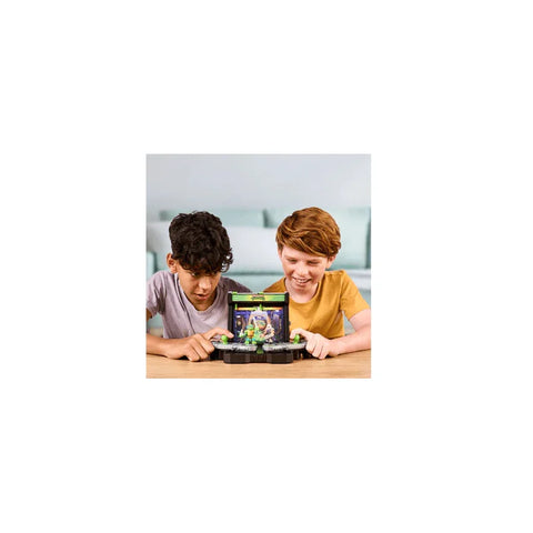 Two kids playing with a Teenage Mutant Ninja Turtles battle arena toy set at a table