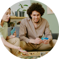 Two people playing a board game together in a cozy living room.