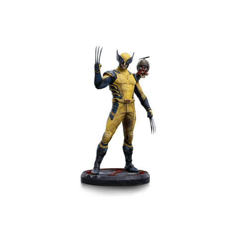 Yellow-suited Wolverine collectible figure holding Headpool, detailed hero statue on base