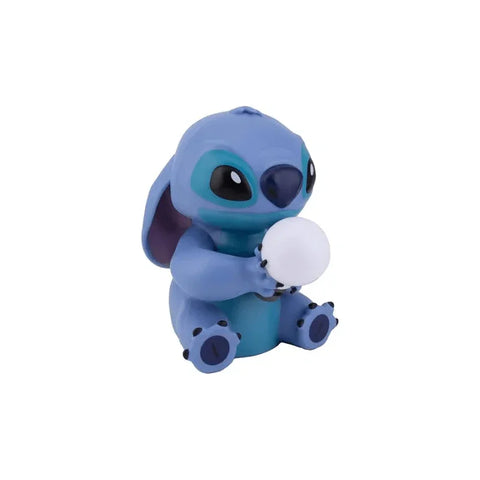 Blue alien character toy figure holding a white ball collectible on white background