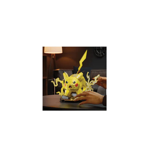 Pikachu 3D puzzle model kit on table with hands assembling collectible toy figure