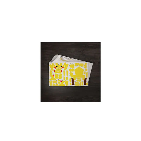 Pikachu 3D puzzle model kit sheets with yellow cut-out pieces on a dark surface