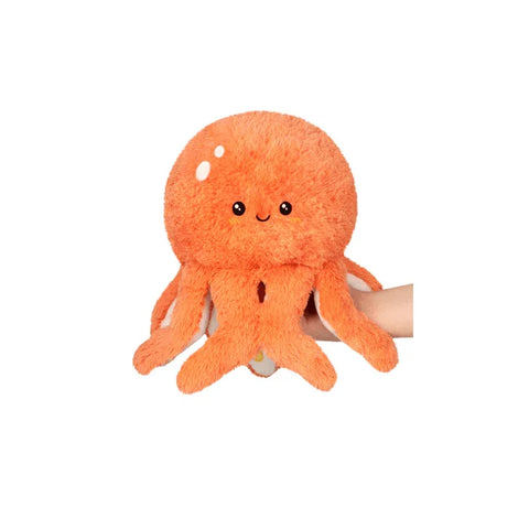 Mini orange octopus plush toy with cute face and soft tentacles, held by a hand
