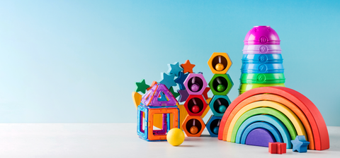 Colorful toy building blocks on a light blue background