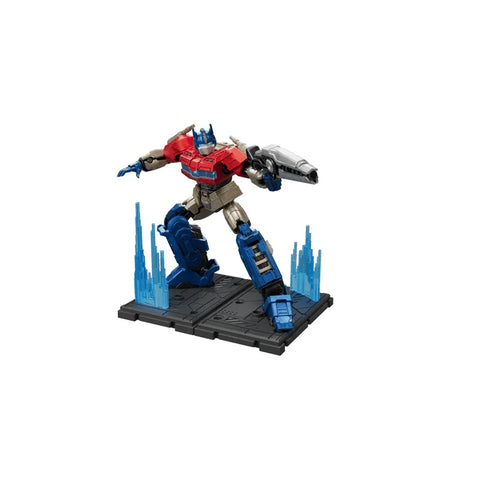 Optimus Prime action figure model kit posed with blaster on display base with blue effects.