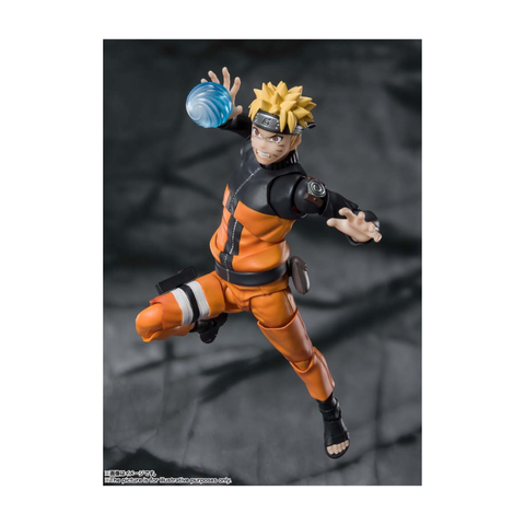 Anime action figure in orange outfit holding blue energy sphere, articulated collectible toy