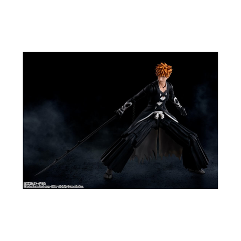 Anime action figure with orange spiky hair, black robe, and large sword on dark background