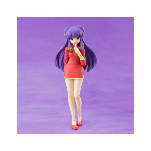 Anime girl figurine with purple hair and red dress on purple background, collectible toy