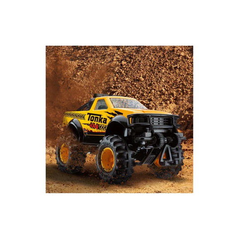 Yellow Tonka toy monster truck driving on dirt, perfect for kids' collectible toy trucks.