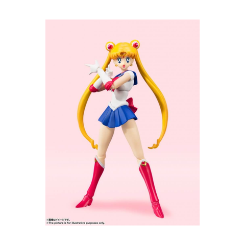 Anime action figure with long blonde hair, red boots, and blue skirt on a pink background.