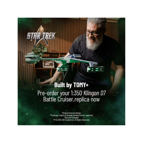 Man admiring Star Trek 1:350 Klingon D7 Battle Cruiser replica model on display indoors