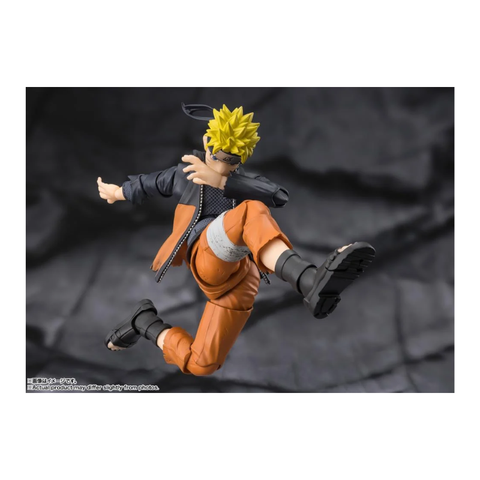 Anime action figure with spiky yellow hair in orange outfit mid-kick, collectible toy