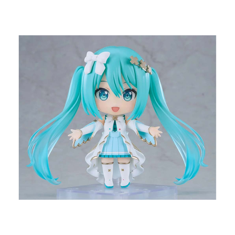 Anime chibi figure with blue twin tails, white and blue outfit, standing on display base