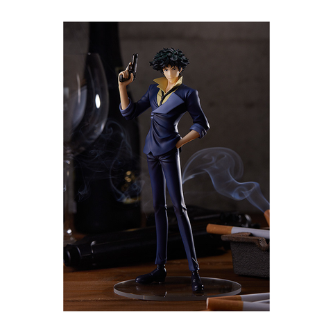 Anime action figure in blue suit holding a gun, surrounded by glasses and cigarette props