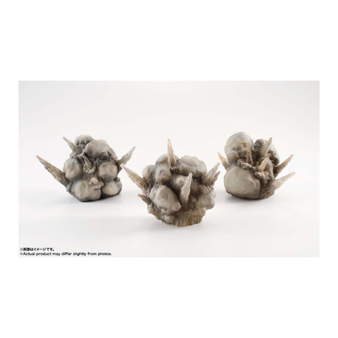 Three spiked gray resin toy rocks on white background, tabletop gaming terrain pieces