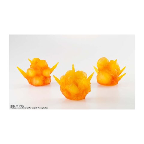 Three orange and yellow explosion effect toy accessories on a white background