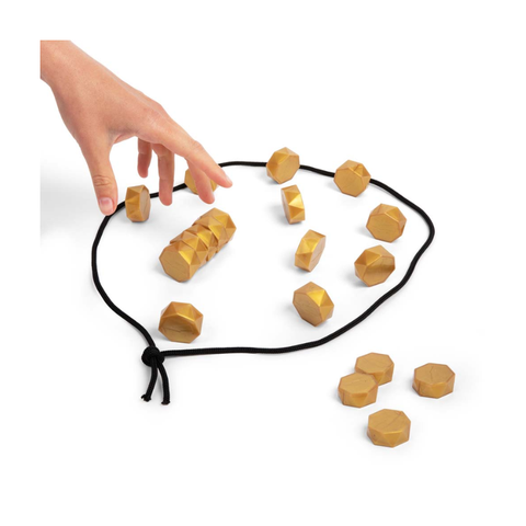 Hand arranging wooden geometric puzzle pieces on black cord, educational toy for kids