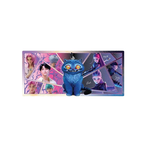 Colorful toy figure of a blue cat in front of anime-style character artwork display