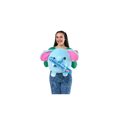 Woman holding a plush blue elephant toy with pink ears and a Mentos-themed design