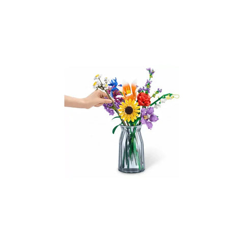 Hand arranging colorful LEGO flower bouquet in glass vase, perfect for games and toys collectors