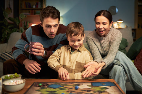 Chessboard with green and gold chess pieces on a marble surface