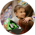 Child holding a toy car with a woman in a store setting