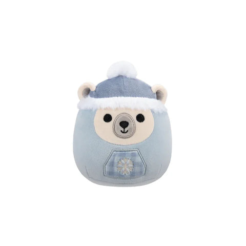 Cute polar bear plush toy with blue winter hat and snowflake patch, isolated on white
